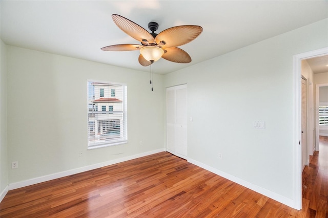 empty room featuring hardwood / wood-style flooring and ceiling fan