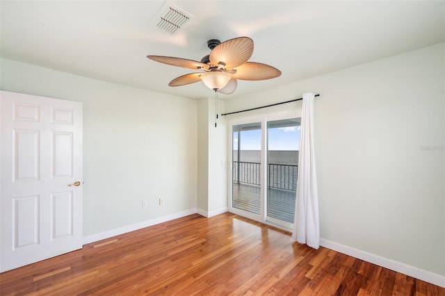 empty room with ceiling fan and wood-type flooring