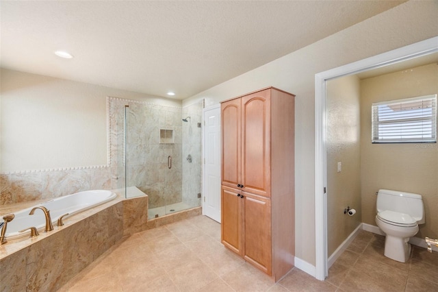 bathroom featuring toilet and independent shower and bath