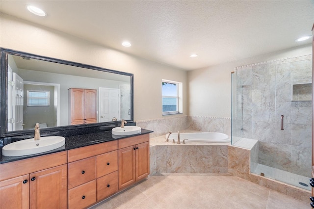 bathroom with vanity, tile patterned floors, independent shower and bath, and a textured ceiling