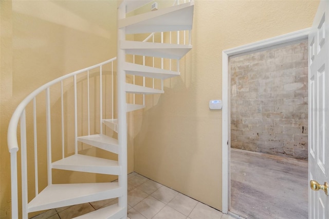 stairway featuring tile patterned flooring