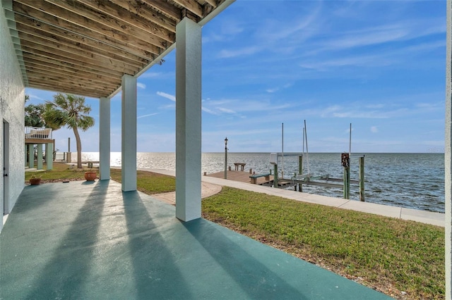 view of patio / terrace featuring a water view and a dock