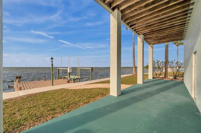 view of patio with a water view and a boat dock