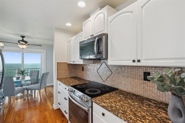6423 Driftwood Dr, Hudson, FL 34667 - kitchen featuring appliances with stainless steel finishes, light wood-style floors, white cabinetry, and recessed lighting