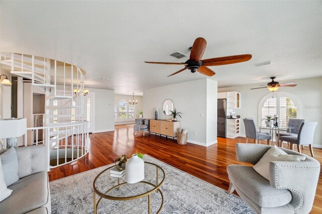 6423 Driftwood Dr, Hudson, FL 34667 - living area featuring a chandelier, a ceiling fan, wood finished floors, and baseboards