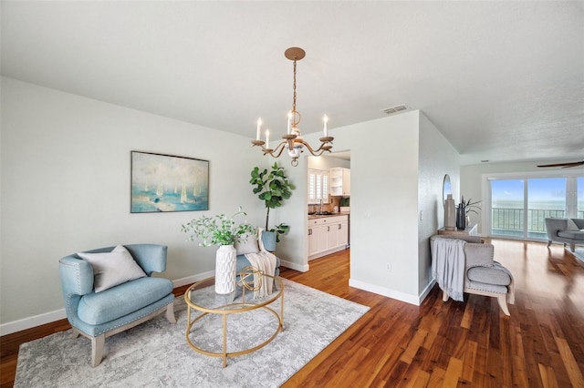 6423 Driftwood Dr, Hudson, FL 34667 - sitting room featuring a chandelier, wood finished floors, and baseboards