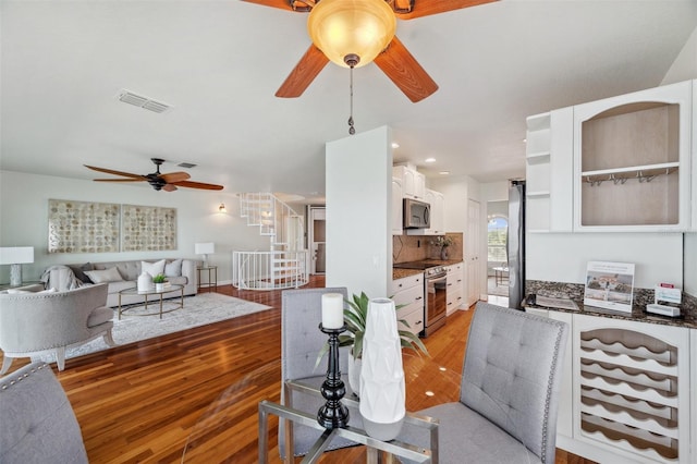 6423 Driftwood Dr, Hudson, FL 34667 - living room with ceiling fan, stairs, light wood-style flooring, and recessed lighting