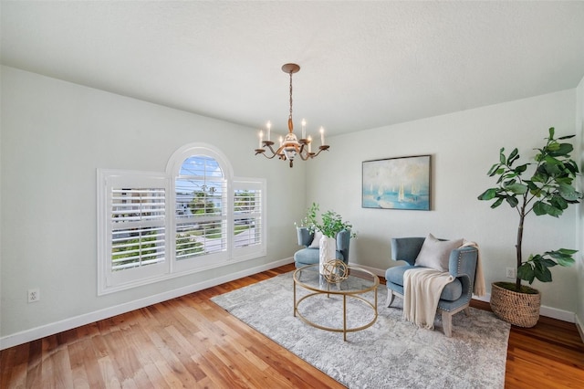 6423 Driftwood Dr, Hudson, FL 34667 - living area with a chandelier, wood finished floors, and baseboards