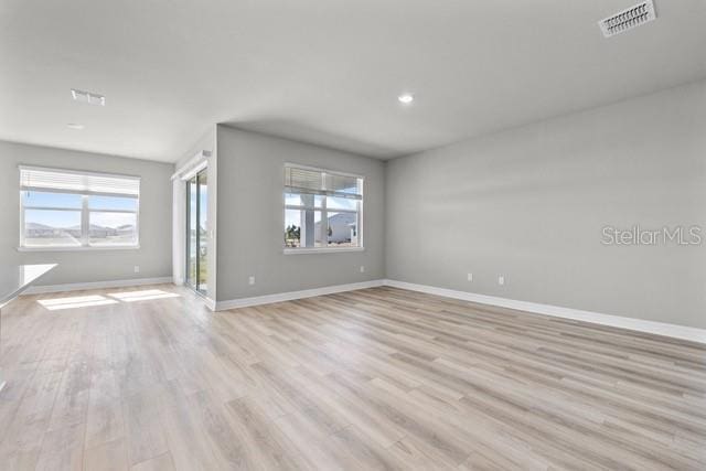 unfurnished living room with light hardwood / wood-style flooring