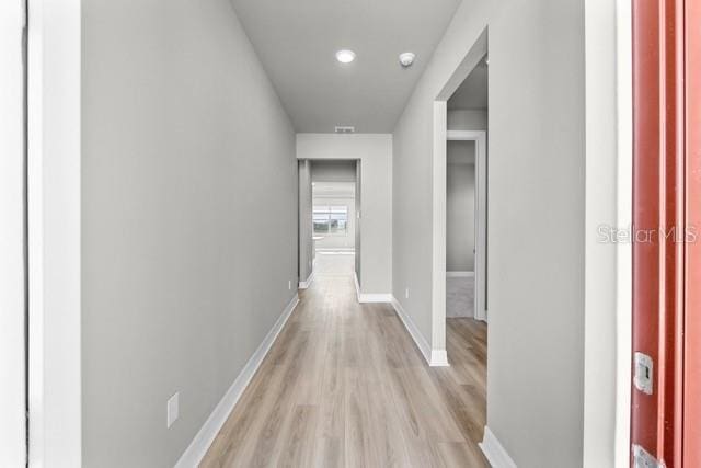 hallway with light wood-type flooring