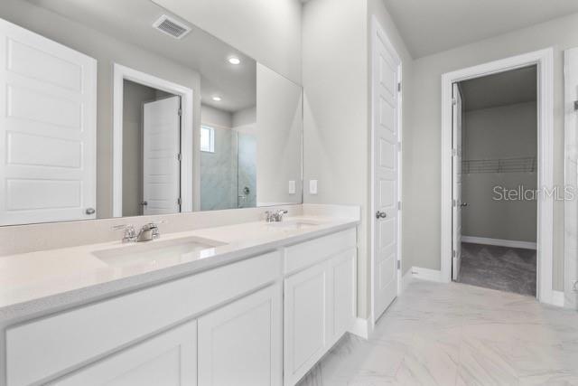 bathroom with vanity and a shower with shower door