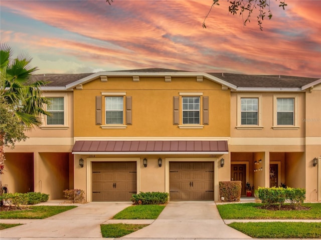 townhome / multi-family property featuring a garage