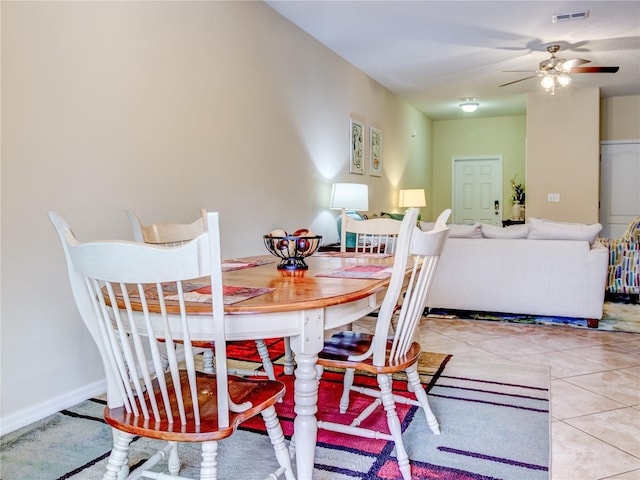 tiled dining room with ceiling fan