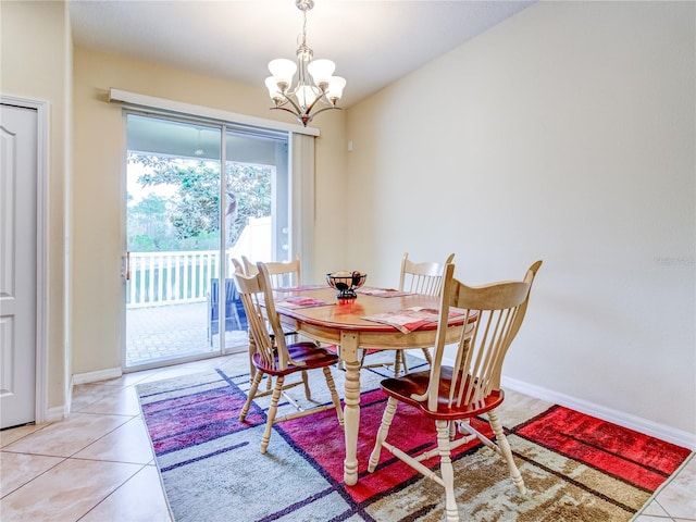 dining space featuring light tile patterned floors and a chandelier