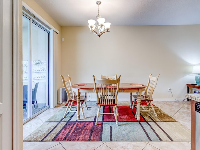 dining area featuring light tile patterned floors and a chandelier