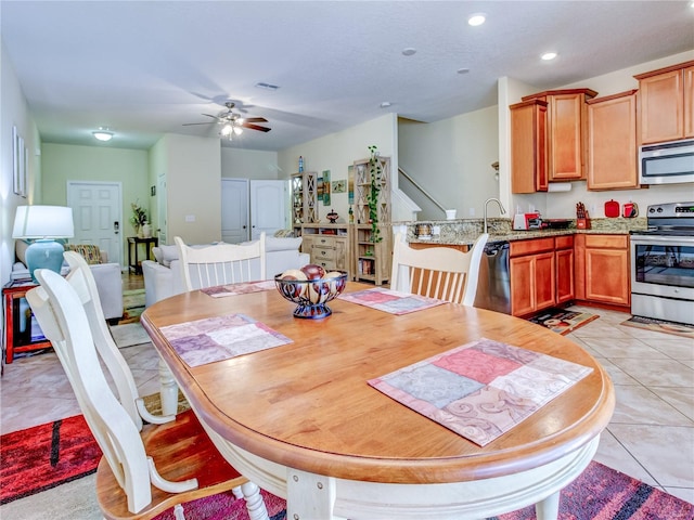 dining room featuring ceiling fan and light tile patterned floors