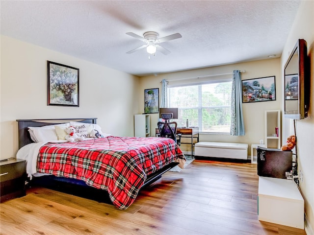 bedroom featuring a textured ceiling, ceiling fan, and hardwood / wood-style flooring