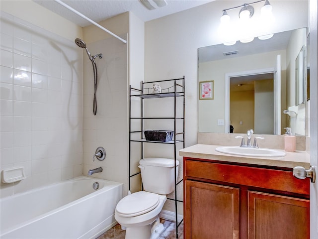 full bathroom with toilet, tiled shower / bath, and vanity