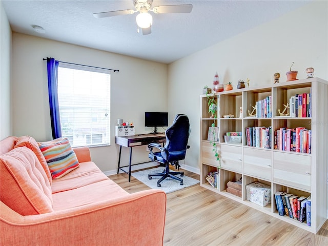 office space with ceiling fan, a wealth of natural light, and hardwood / wood-style floors