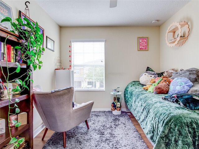 bedroom with ceiling fan and hardwood / wood-style floors