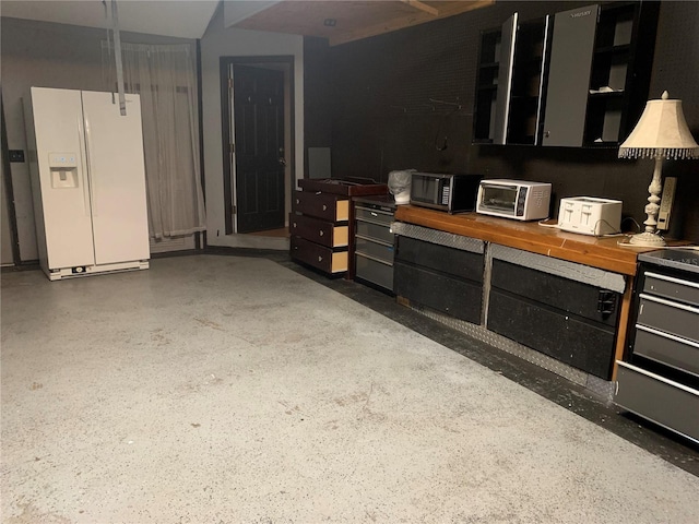 interior space featuring white refrigerator with ice dispenser