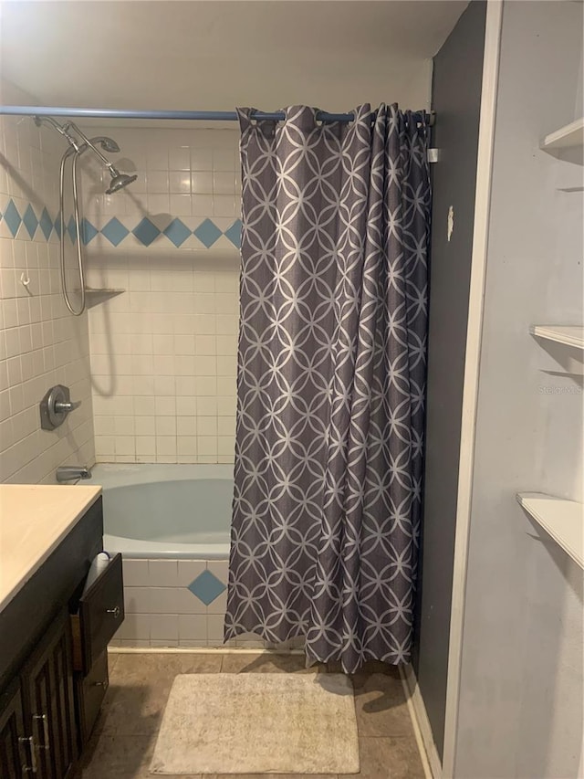 bathroom with tile patterned flooring, vanity, and shower / tub combo