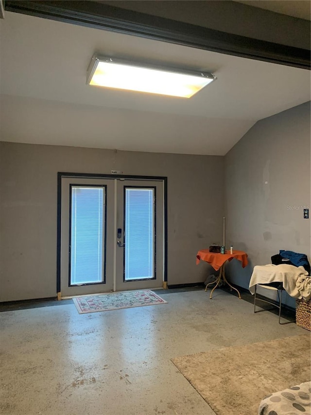 spare room featuring vaulted ceiling