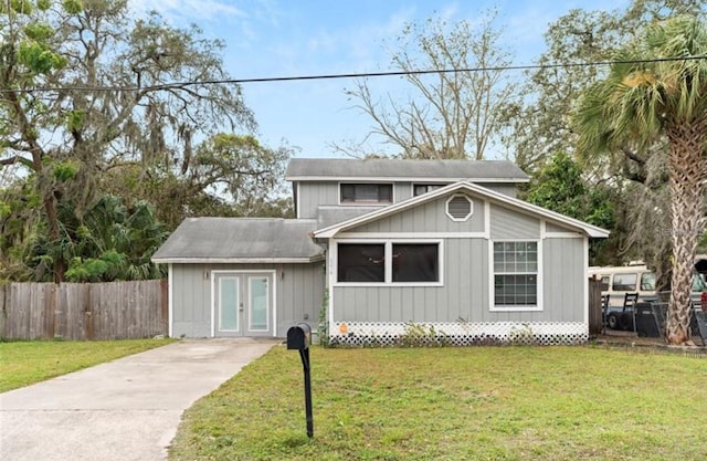 view of front of property featuring french doors and a front lawn