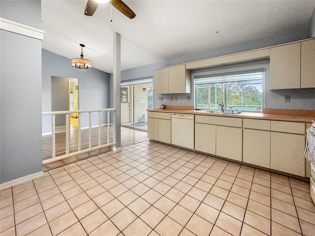 kitchen featuring pendant lighting, cream cabinets, white dishwasher, ceiling fan with notable chandelier, and sink