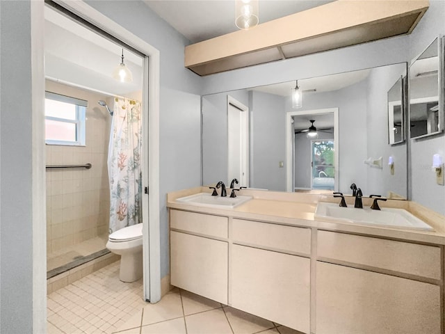 bathroom with vanity, tile patterned floors, a shower with curtain, ceiling fan, and toilet