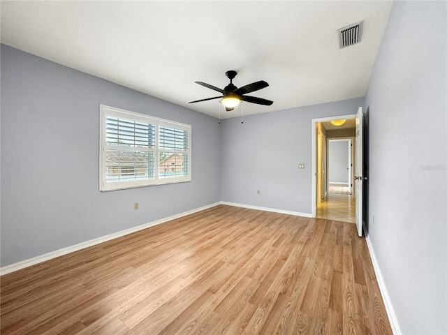 unfurnished room with ceiling fan and light wood-type flooring