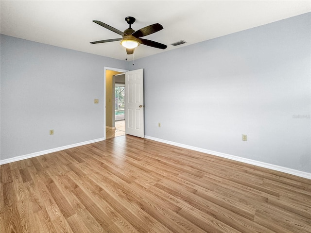 empty room with ceiling fan and light wood-type flooring