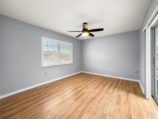 empty room with ceiling fan and light hardwood / wood-style floors