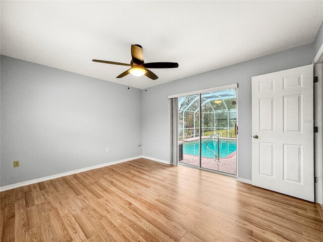 spare room featuring light wood-type flooring and ceiling fan