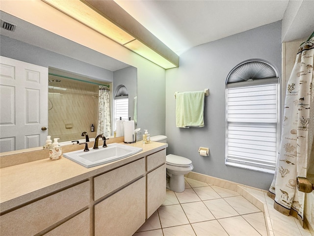 bathroom with walk in shower, tile patterned flooring, vanity, and toilet