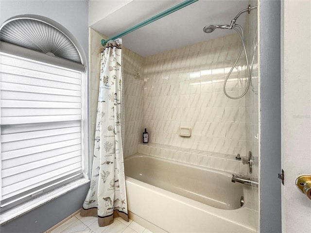 bathroom with tile patterned floors and shower / bath combo with shower curtain