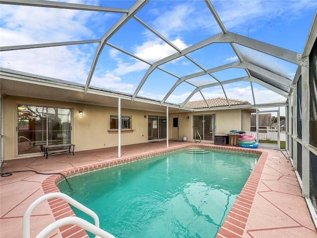 view of pool with a patio area and a lanai