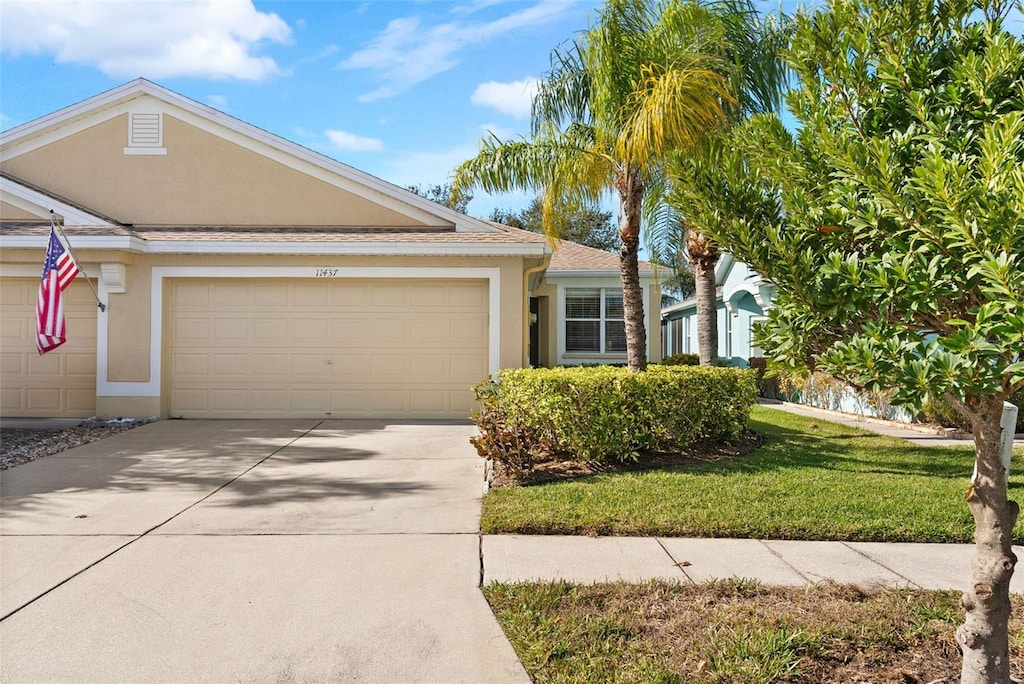 view of front facade with a front lawn and a garage