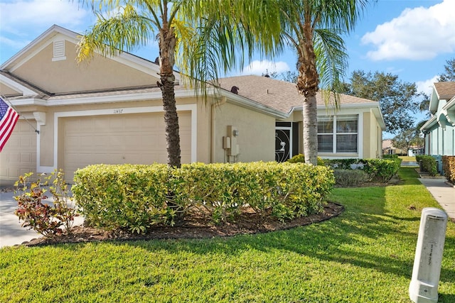 ranch-style home featuring a front lawn and a garage