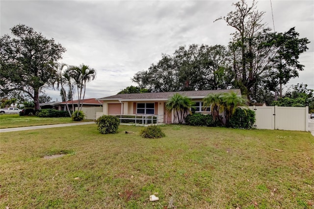 ranch-style home with a front lawn