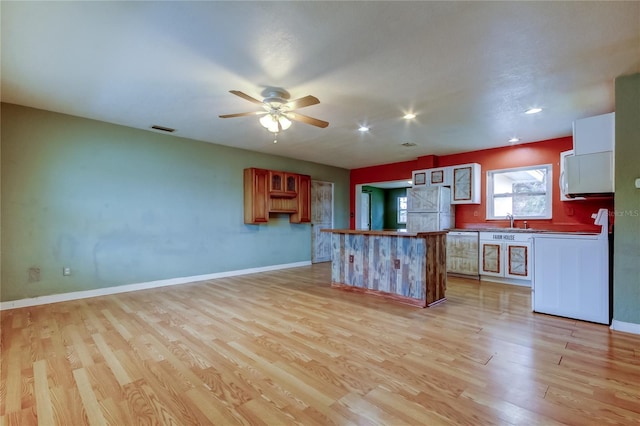 kitchen with sink, light hardwood / wood-style flooring, and dishwasher