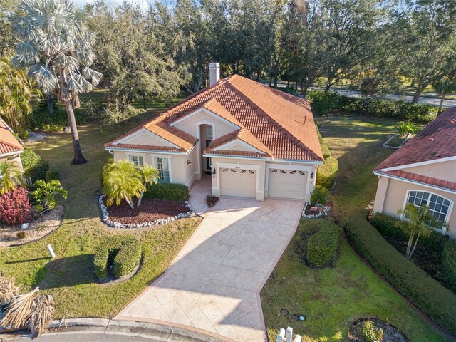 mediterranean / spanish home with a garage