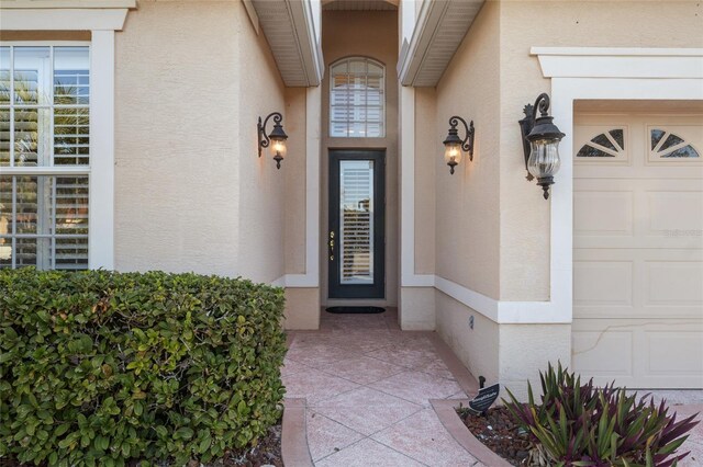 view of exterior entry with a garage