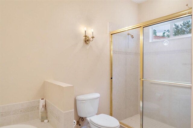 bathroom with toilet and an enclosed shower