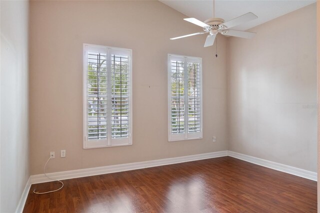 empty room featuring ceiling fan, dark wood-type flooring, and lofted ceiling