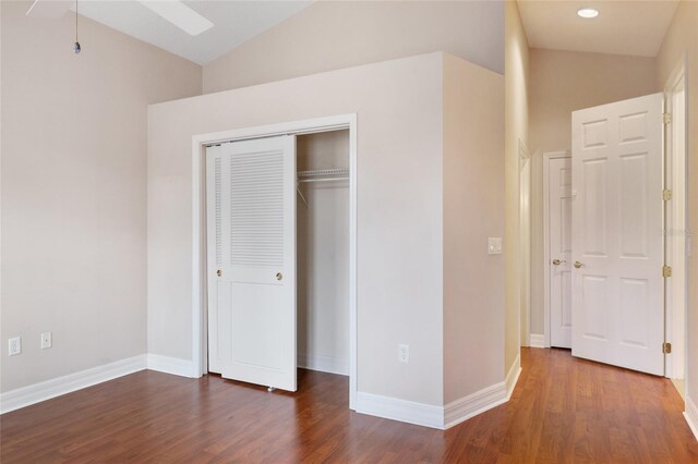 unfurnished bedroom featuring ceiling fan, dark wood-type flooring, and lofted ceiling