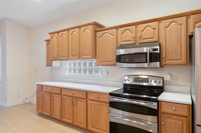 kitchen with stainless steel appliances and light wood-type flooring