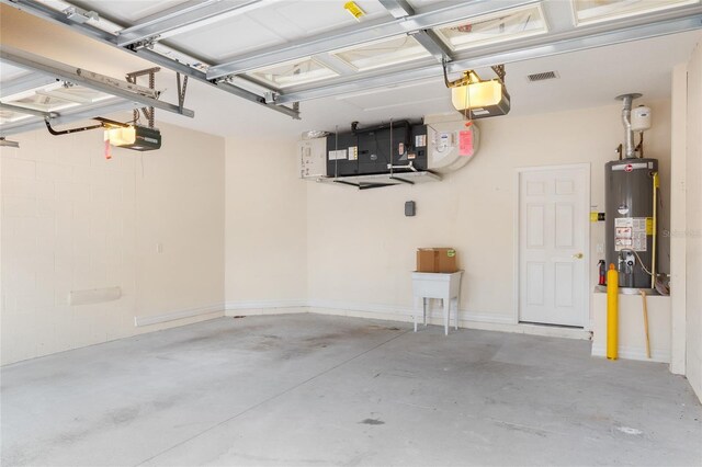 garage with water heater and a garage door opener