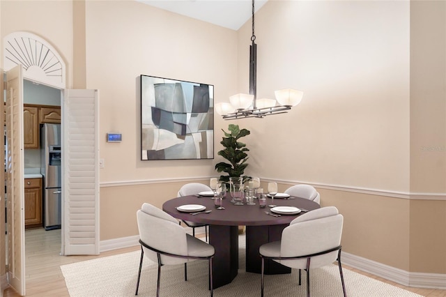 dining room featuring a notable chandelier and light hardwood / wood-style flooring