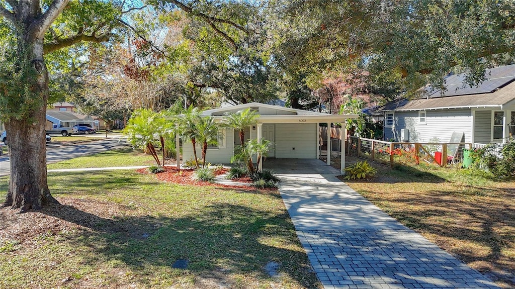 bungalow featuring a front yard and a carport